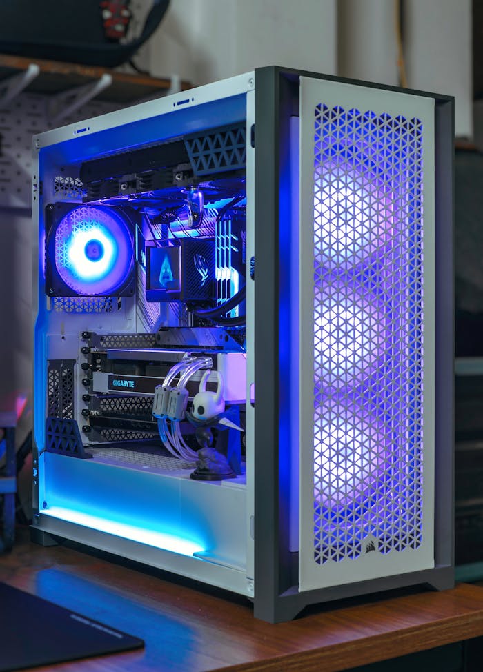services-03 A sleek desktop PC with vibrant blue RGB lighting showcasing modern computer technology.